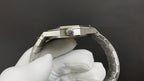 Audemars Piguet watch crown and case top in silver with bracelet links visible