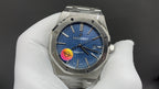 Audemars Piguet watch with blue dial, silver octagonal case, three-hand display