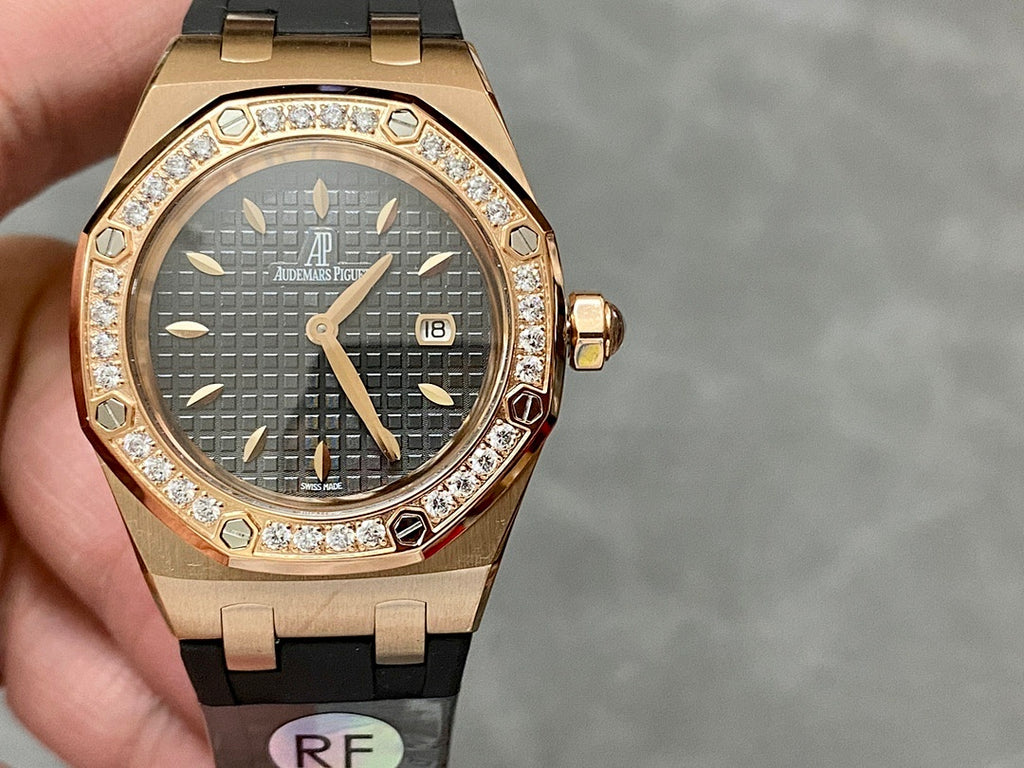 Rose gold Royal Oak watch with diamond bezel, dark dial and date window, black strap