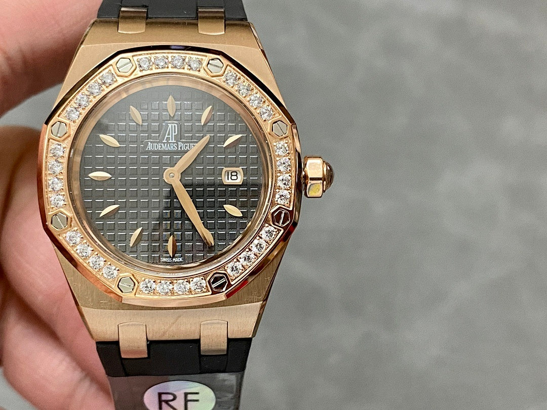 Rose gold Royal Oak watch with diamond bezel, dark dial and date window, black strap