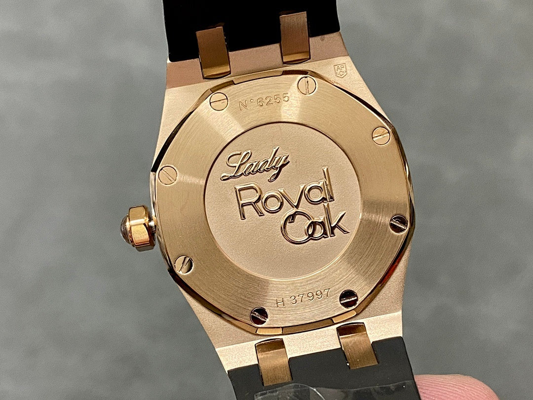 Rose gold Royal Oak case back with engraved text and screw details, black strap