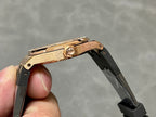 Rose gold Royal Oak watch case side with crown and black rubber strap