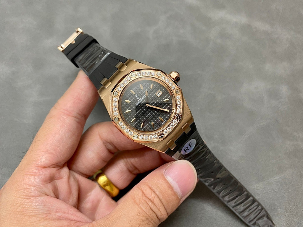 Rose gold Royal Oak watch with diamond bezel, dark dial and black rubber strap