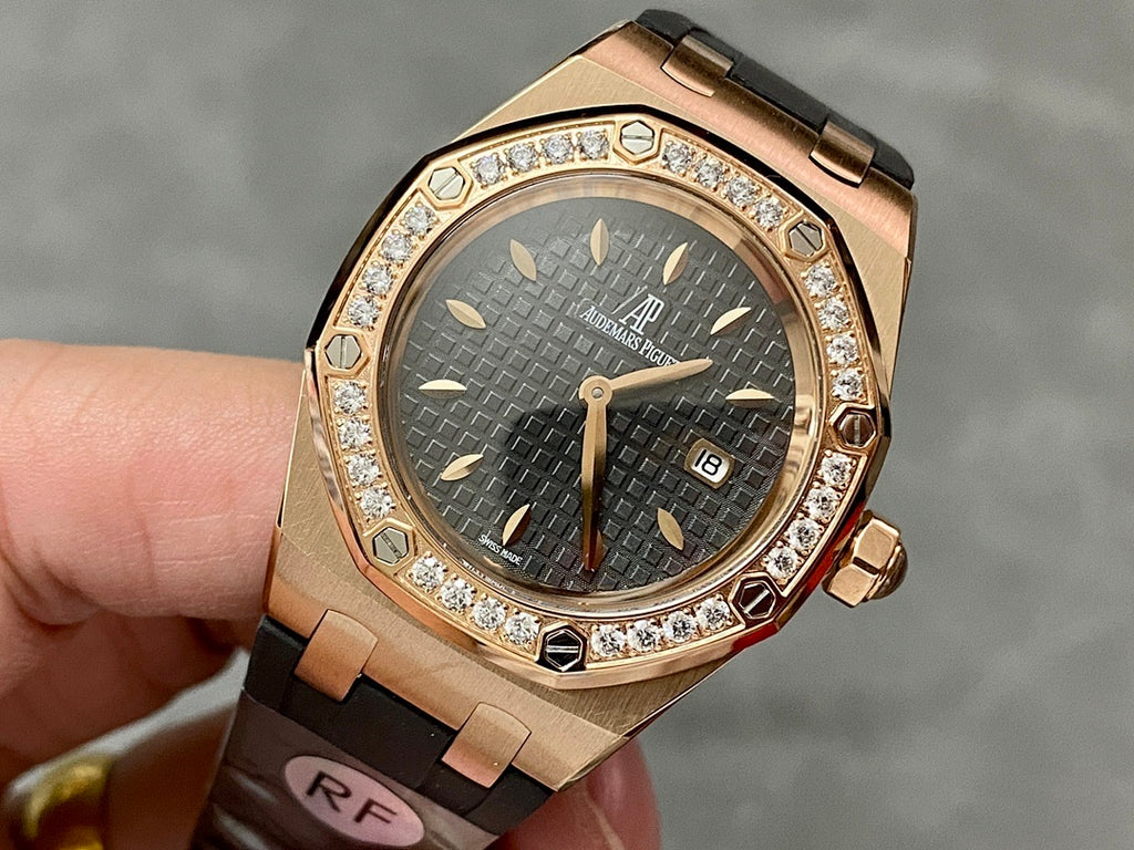 Rose gold Royal Oak watch with diamond bezel, dark dial and black rubber strap