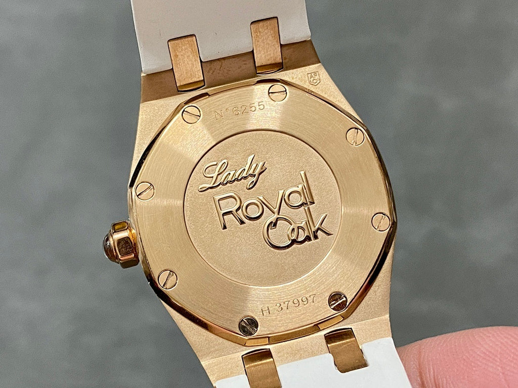 Rose gold-tone case back with “Lady Royal Oak” text and white rubber strap.