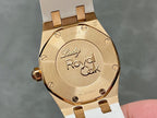 Rose gold-tone case back with “Lady Royal Oak” text and white rubber strap.