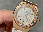 Rose gold-tone watch with white dial, diamond bezel, and white rubber strap.