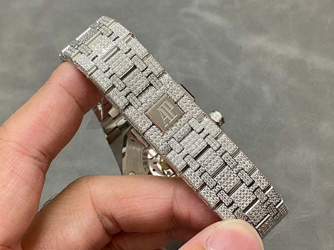 Diamond-studded bracelet with rectangular links and engraved centerpiece on the band