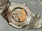 Luxury watch case back with exposed mechanical movement and diamond-set bezel