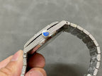 Diamond-studded watch side with blue dial detail on the crown and bracelet