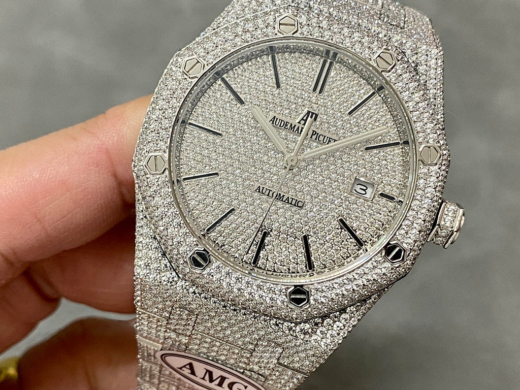 Silver-toned diamond-studded luxury watch with round face and segmented bezel