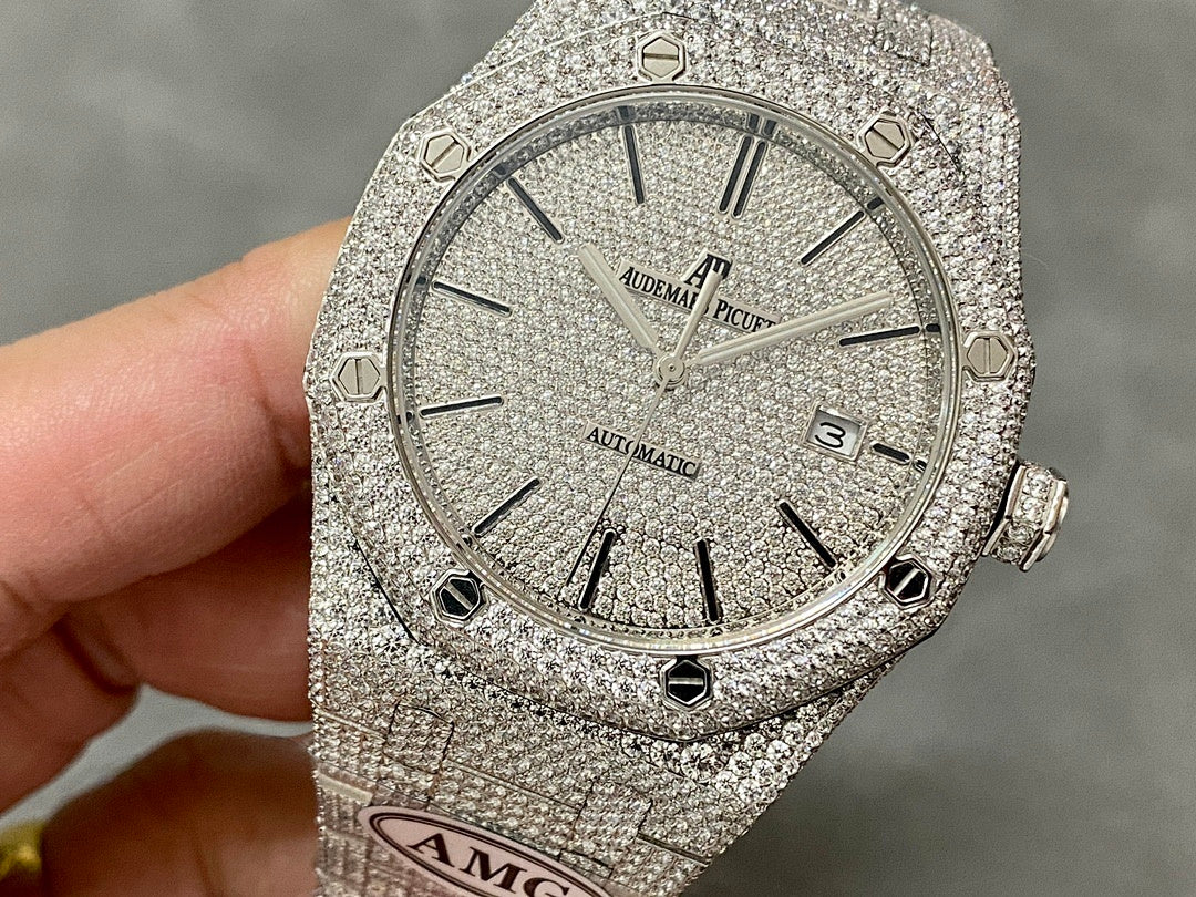 Silver-toned diamond-studded luxury watch with round face and segmented bezel