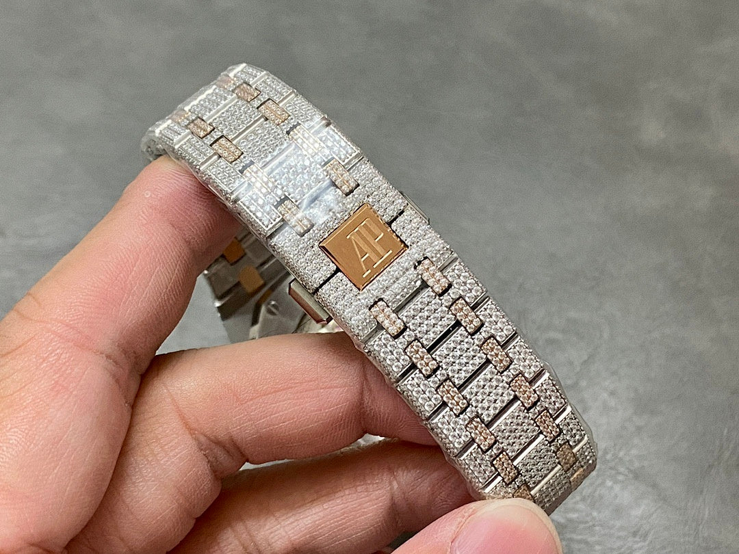 Diamond and gold-toned bracelet segment on a wristwatch, angled close-up