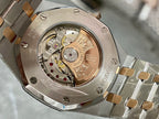 Wristwatch caseback close-up showing internal movement and engraved ring