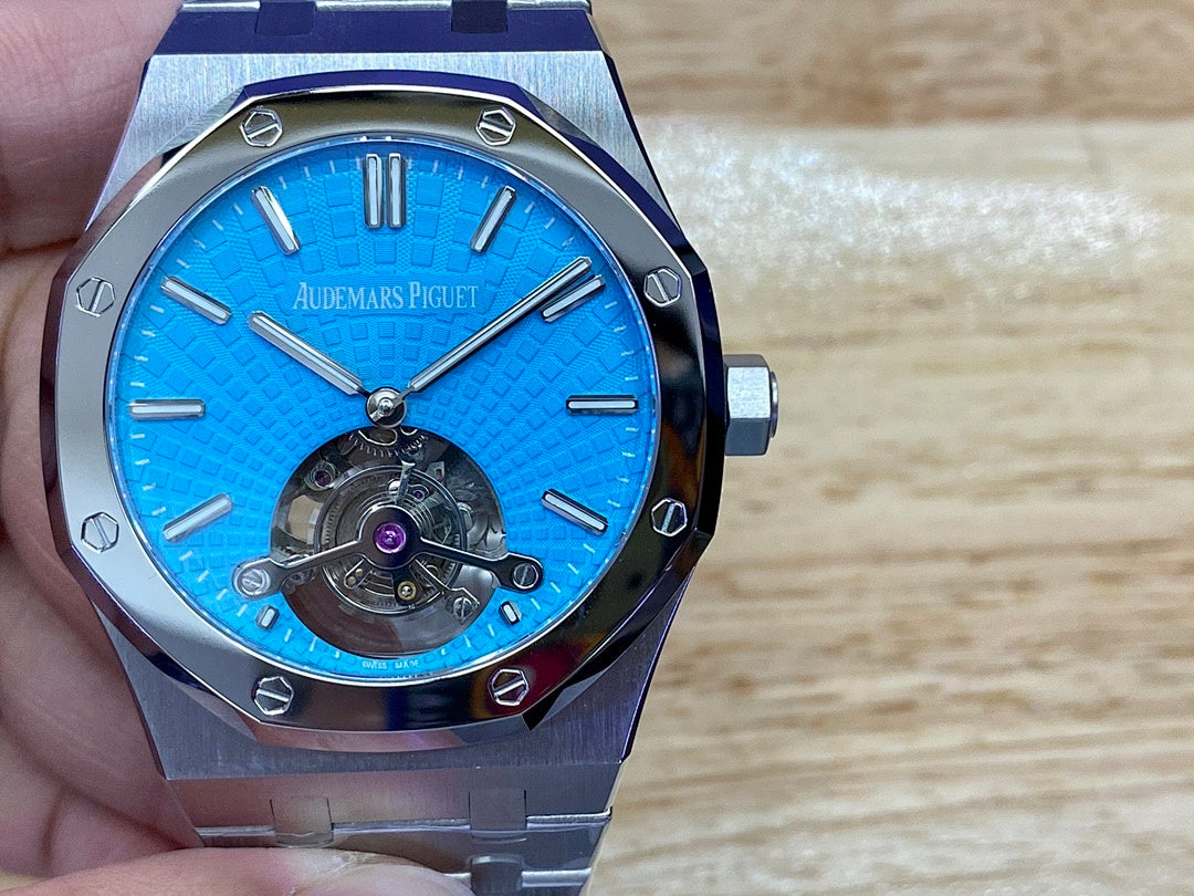 Audemars Piguet watch with blue textured face and visible mechanical movement