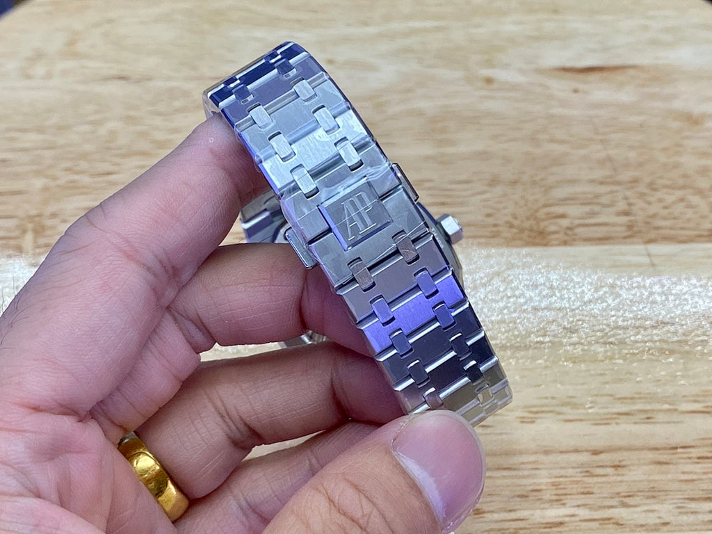 Audemars Piguet stainless steel bracelet links with blue-toned accents