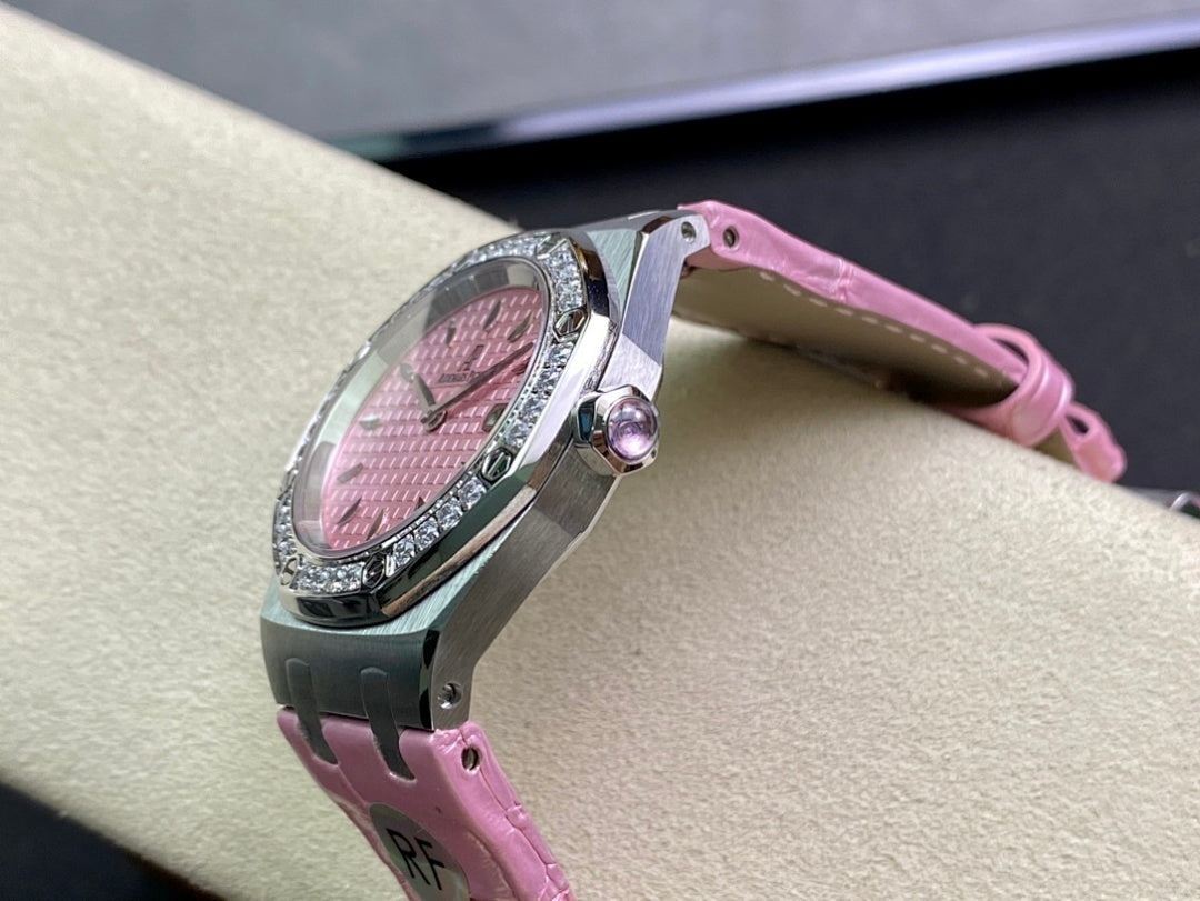 Steel wristwatch case side with crown and pink leather strap