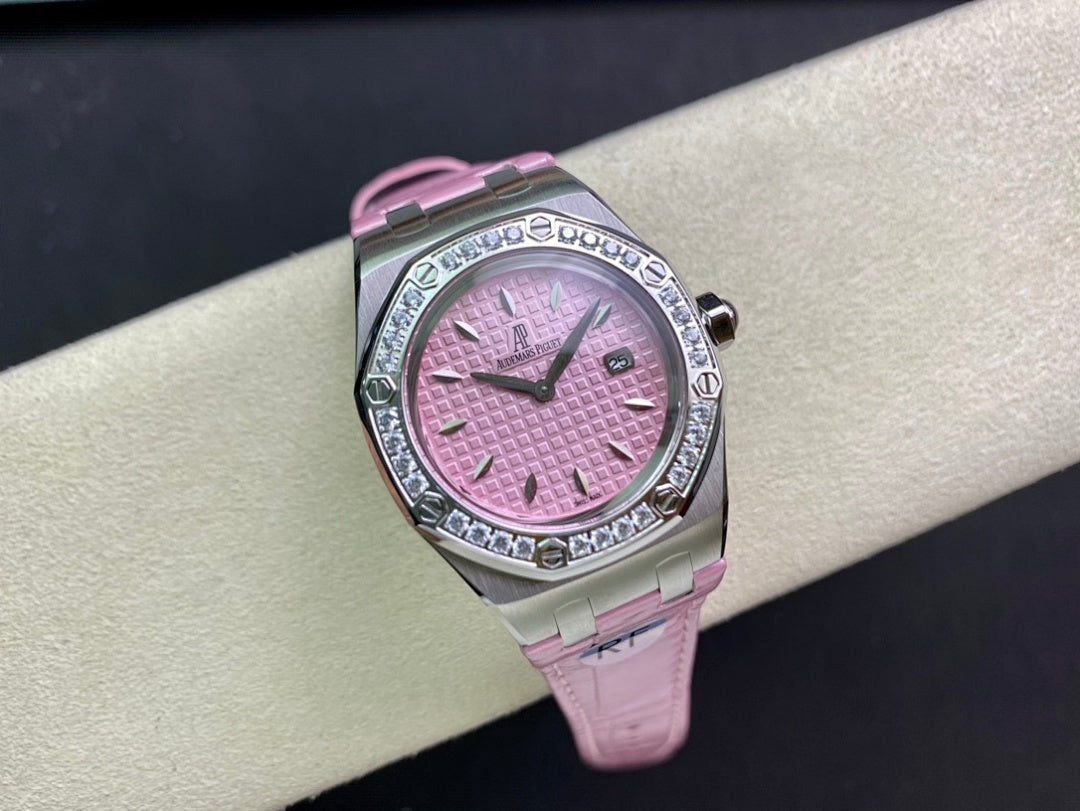 Pink dial wristwatch with diamond bezel and pink leather strap on cushion