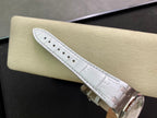White leather watch strap with perforated stitching and metal clasp