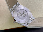 Audemars Piguet watch caseback with engraved logo and metal bracelet link