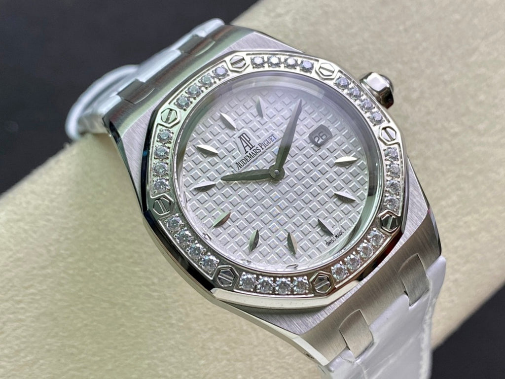 Audemars Piguet wristwatch close-up of white dial and diamond bezel, silver bracelet