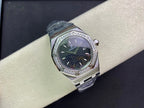 Audemars Piguet watch with round silver case, dark green dial, diamond bezel, blue strap