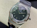 Audemars Piguet watch with silver case, dark green textured dial, diamond bezel, blue strap