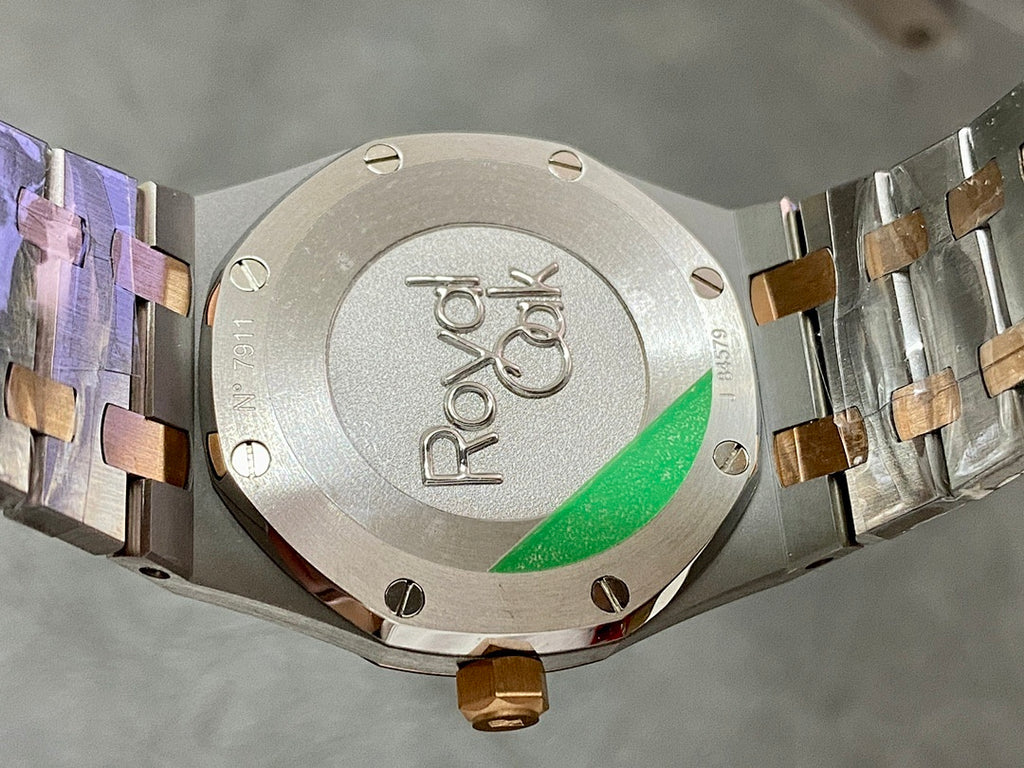Audemars Piguet watch caseback with ROYAL OAK marking and green accent window