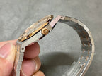 Audemars Piguet watch side profile with gold crown and steel case