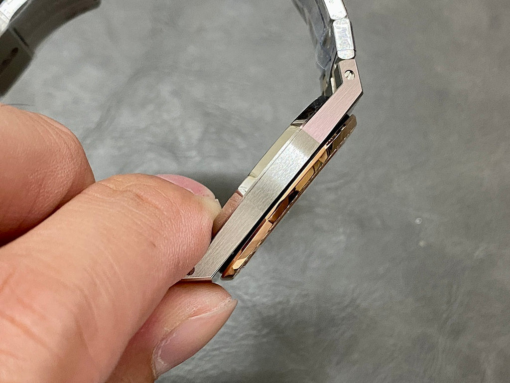 Audemars Piguet watch side view showing rose-gold stripe and steel case edge