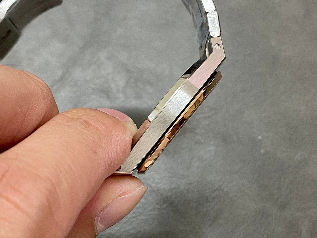 Audemars Piguet watch side view showing rose-gold stripe and steel case edge