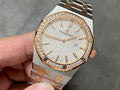Audemars Piguet watch with diamond bezel, white dial, and steel-and-gold link bracelet