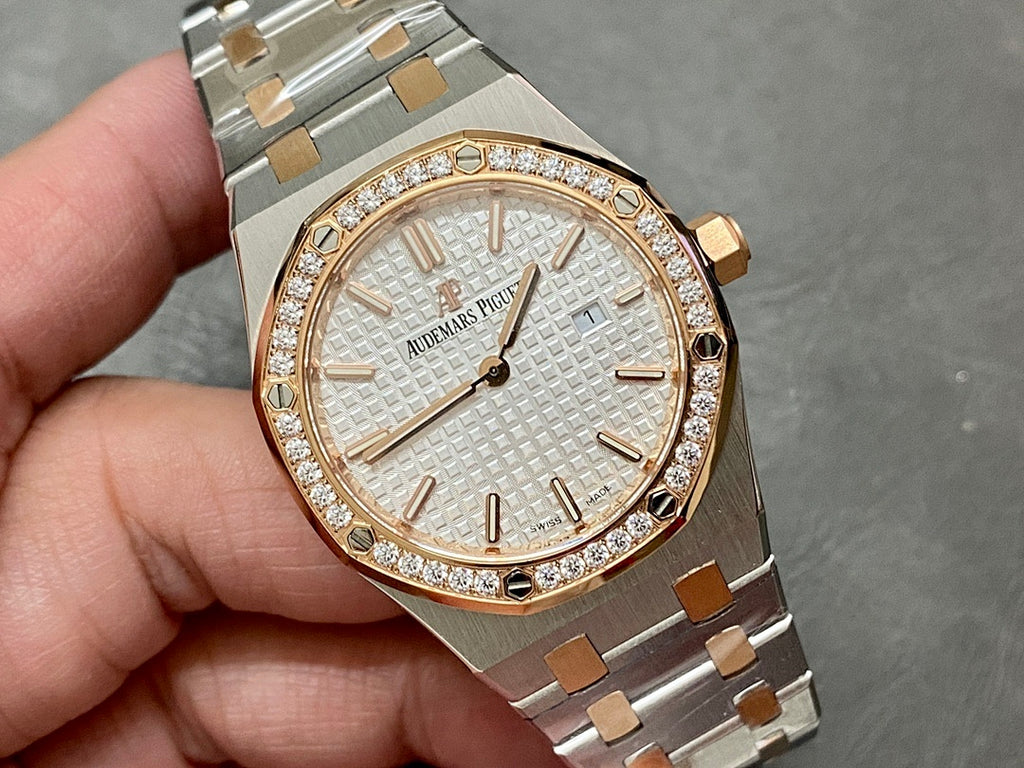 Audemars Piguet watch close-up with white dial, gold markers, and diamond-set bezel