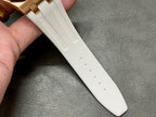 White rubber watch strap with evenly spaced holes along the length
