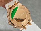 Rose-gold watch caseback with screws and markers, paired with white rubber strap