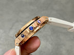 Rose-gold watch side profile with crown and pushers, blue inset accents, white strap