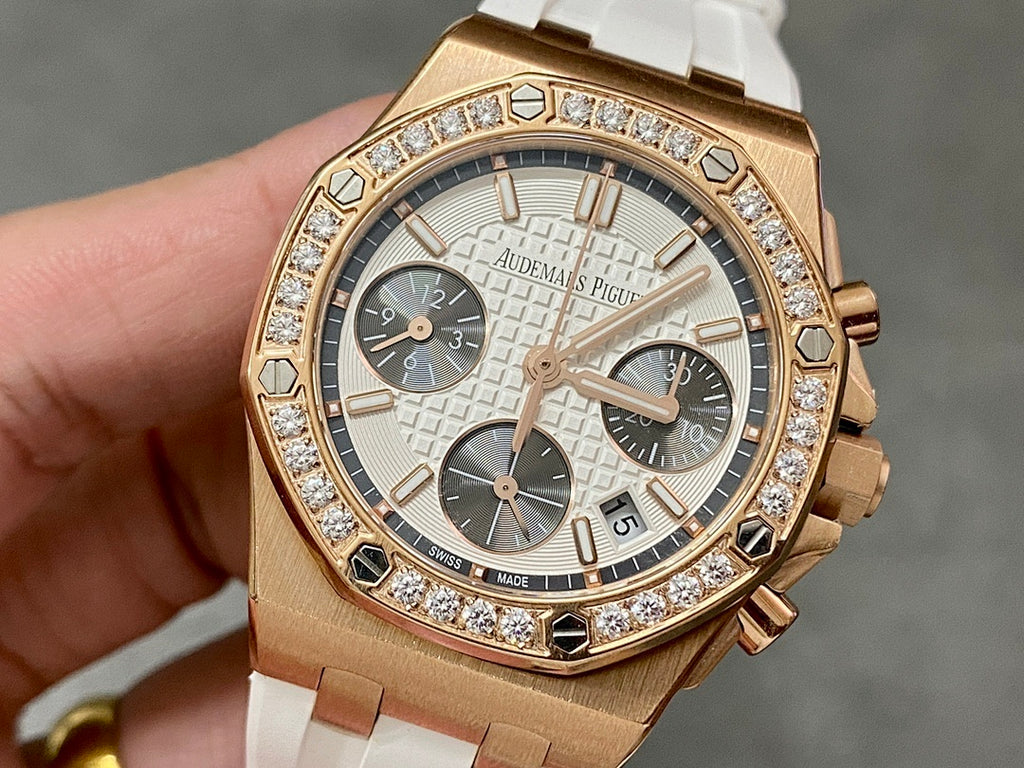 Audemars Piguet chronograph watch with rose-gold case, diamond bezel, white rubber strap