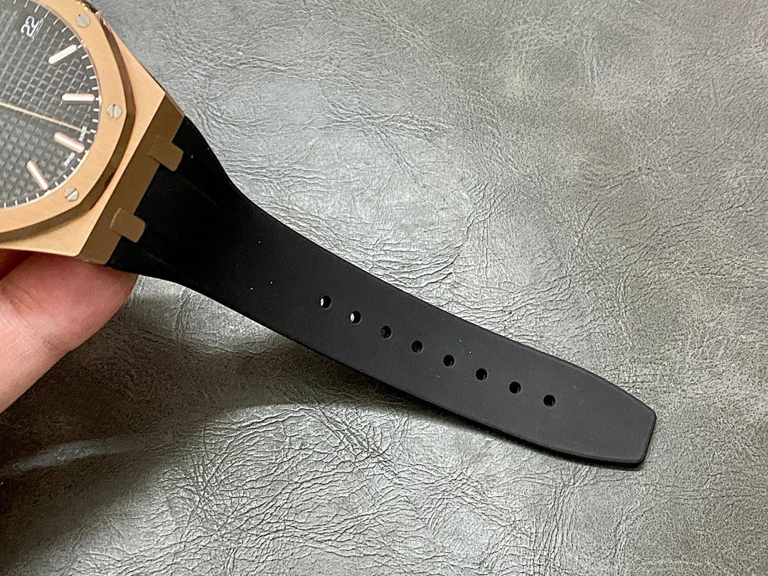 Black rubber watch strap with multiple rows of vent holes.