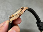 Rose-gold luxury wristwatch side profile with crown and black rubber strap.