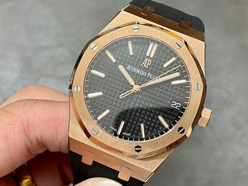 Rose-gold luxury wristwatch with black textured dial and black rubber strap.