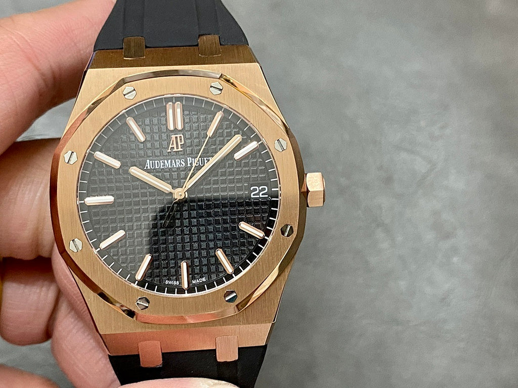 Rose-gold luxury wristwatch with black textured dial and black rubber strap.