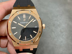 Rose-gold luxury wristwatch with black textured dial and black rubber strap.