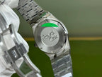 Silver-tone steel watch case back with visible emblem and linked bracelet
