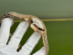 Audemars Piguet gold-toned wristwatch with angled case and bracelet close-up
