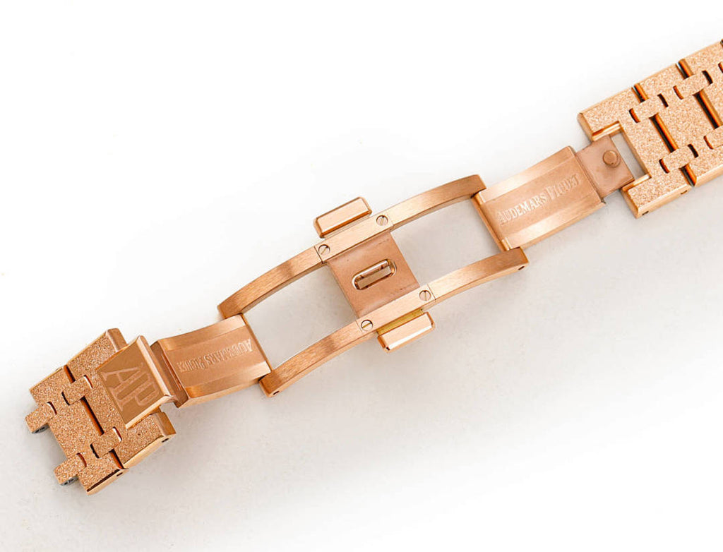 Audemars Piguet rose gold metal watch bracelet with clasp and links.