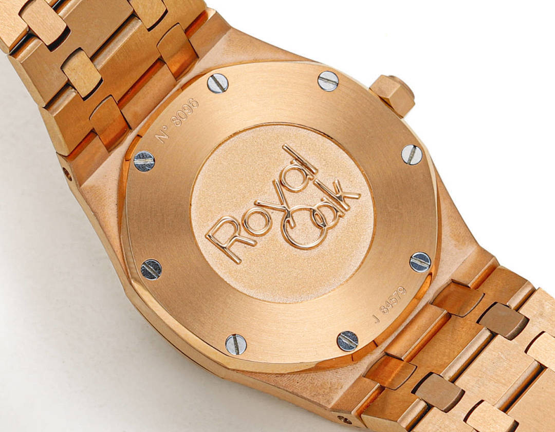 Audemars Piguet rose gold case with engraved caseback medallion and metal bracelet.