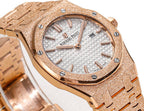 Audemars Piguet rose gold watch face with white textured dial and baton hour markers.