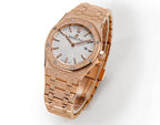 Audemars Piguet rose gold watch angled view with white dial and metal bracelet links.
