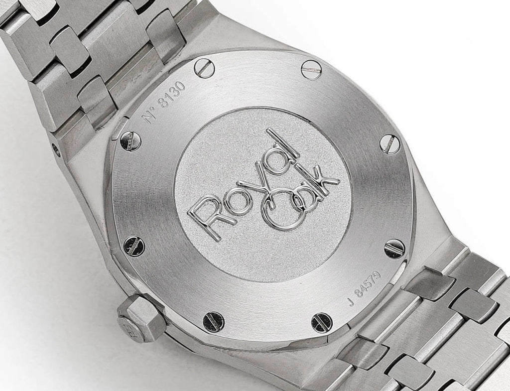 Stainless steel caseback with engraved emblem and metal link bracelet