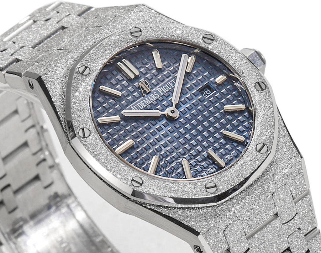 Silver watch with blue patterned dial, baton hour markers, and hands